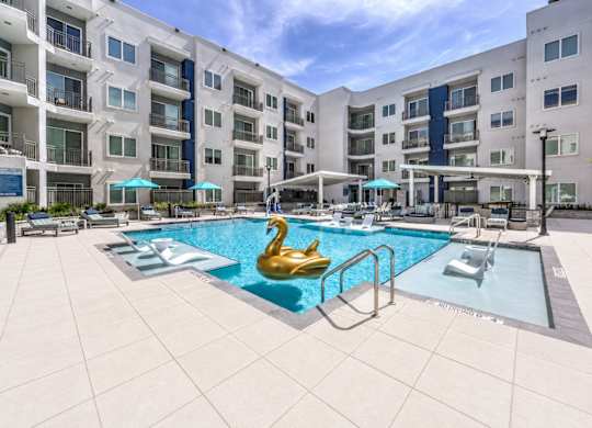 A swimming pool with a golden swan in the middle of it.