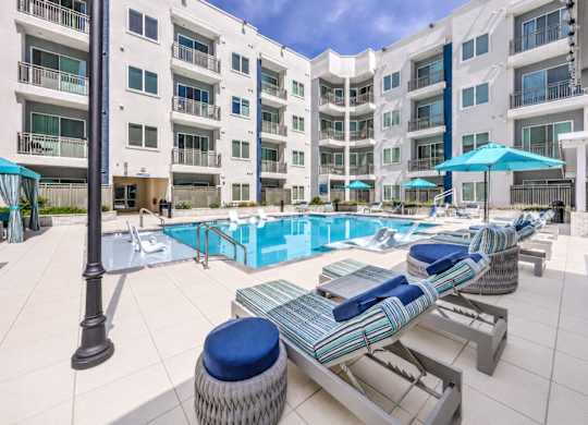 A sunny day at the poolside of a residential building.