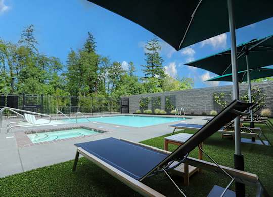 A sun lounger is in the foreground of a swimming pool.