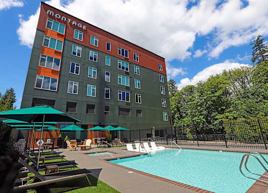 A Montage hotel with a pool and lounge chairs.