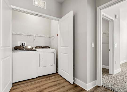 A small laundry room with a washer and dryer.
