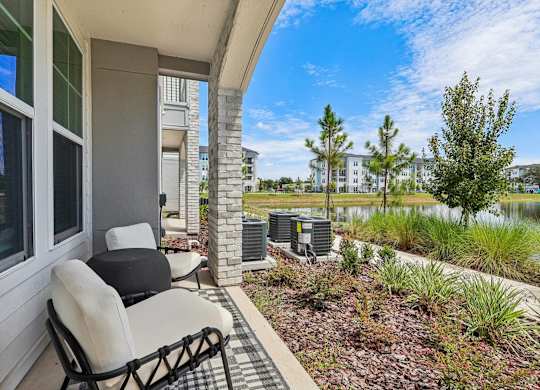 A patio with a chair and a table is shown.