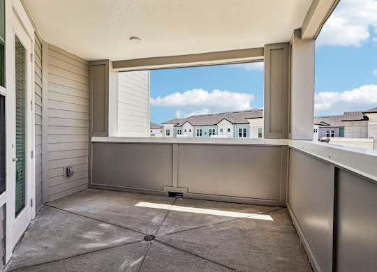A balcony with a view of a residential area.