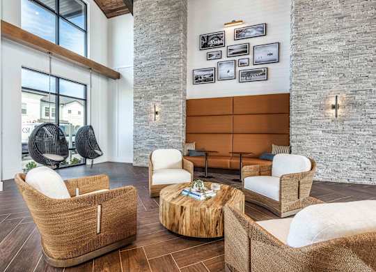 A living room with a wooden floor and a stone wall.