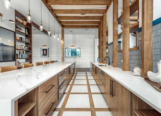 A modern kitchen with wooden cabinets and a white countertop.