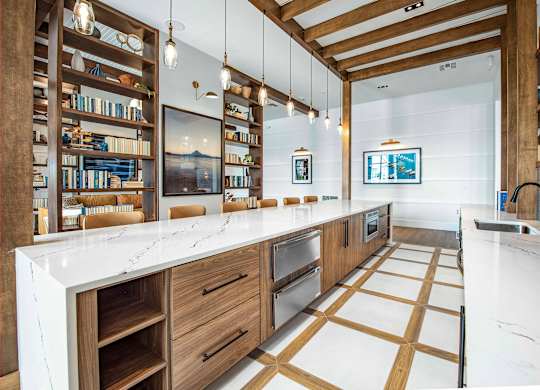 A modern kitchen with wooden cabinets and a white countertop.
