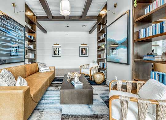 A living room with a sofa, armchairs, and a coffee table.