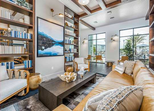A living room with a large couch, a coffee table, and a bookshelf.