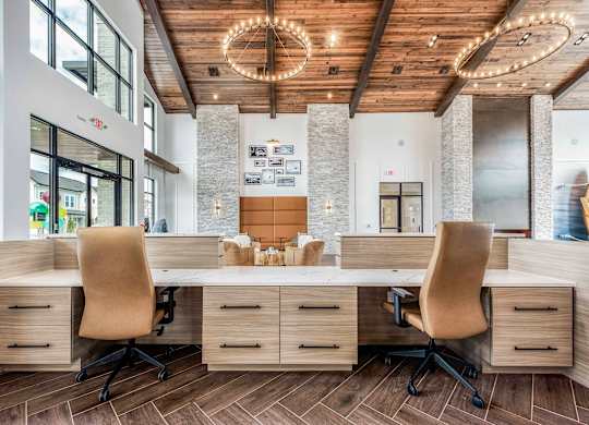 A modern office with a wooden desk and chairs.