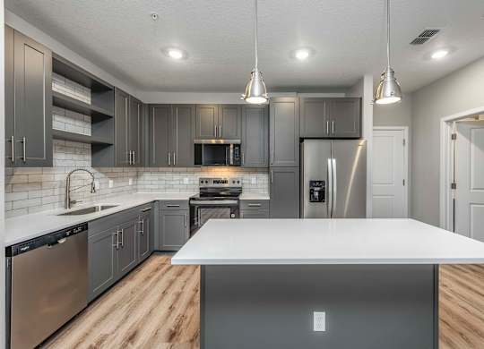 A modern kitchen with a large island in the center.