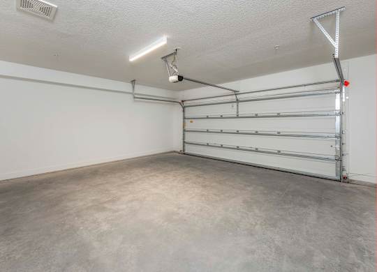 A garage with a white wall and a metal rack.