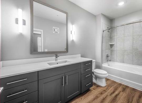 A bathroom with a white sink and a white bathtub.