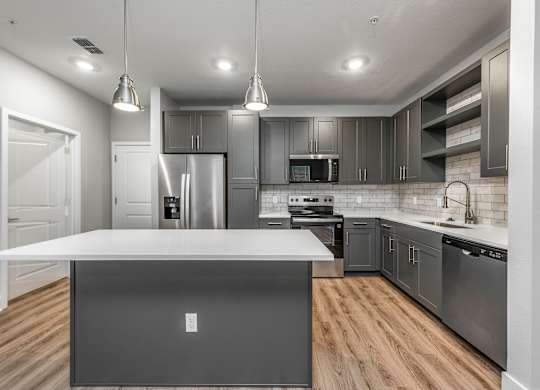 A modern kitchen with a large island in the center.