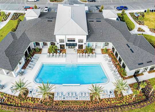 A large house with a pool in the backyard.