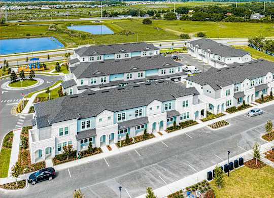 A large white building with a parking lot in front.