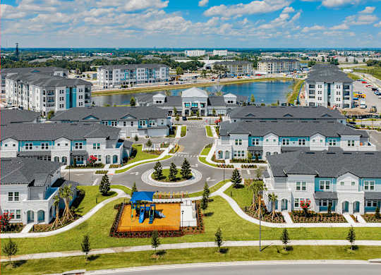A bird's eye view of a residential complex with a playground in the center.