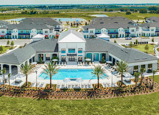A large house with a pool in the front yard.