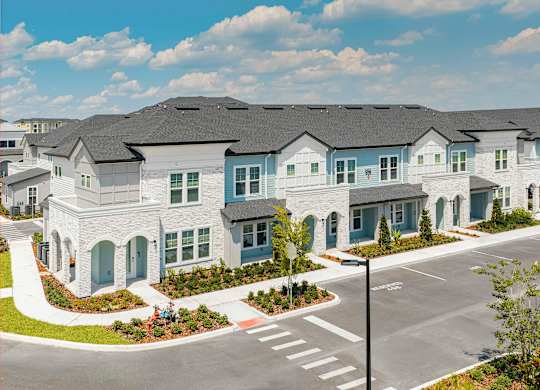 A row of houses with a street in front.