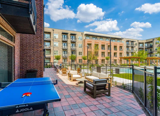 furnished patio with amenities including a ping pong table and a pool