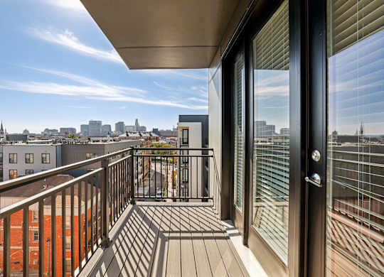 A balcony with a view of a city skyline.