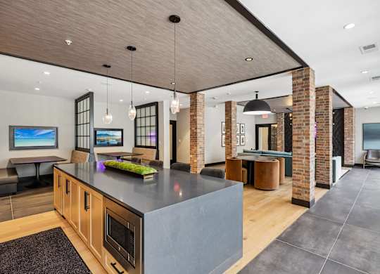 A modern kitchen with a large island and a dining area.