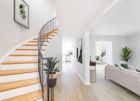 a spiral stairway in a living room with a house plant