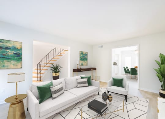 a living room with a white couch and green pillows