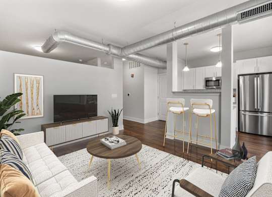A modern living room with a white sofa, a coffee table at CityWay Apartments, Indianapolis, 46204