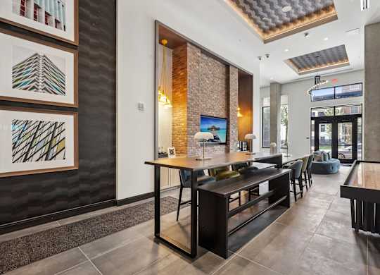 A modern dining area with a long table and chairs.
