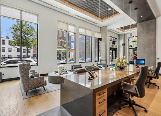A modern office with a long table and chairs.