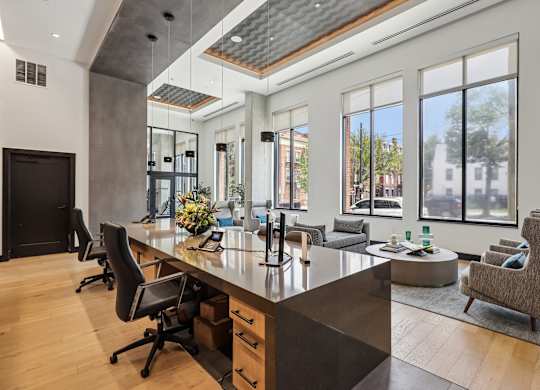 A modern home office with a large desk and chairs.