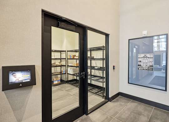 A black door with a glass window is open.