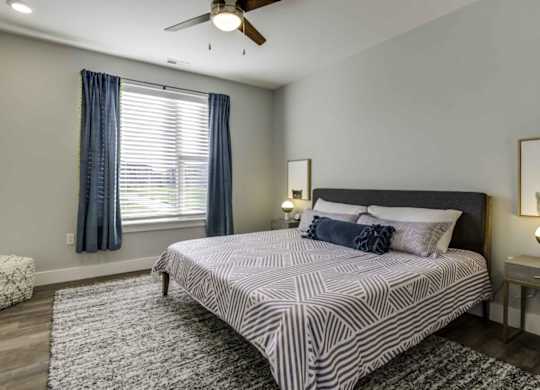 a bedroom with a bed and a ceiling fan at Echo Park at Perry Crossing Apartments, Plainfield, 46168