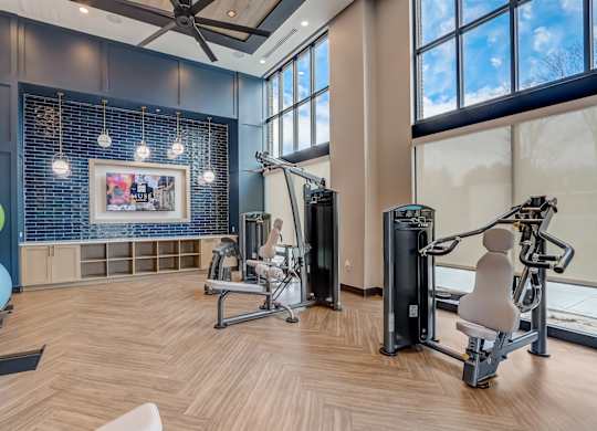 a gym with exercise equipment and a large window