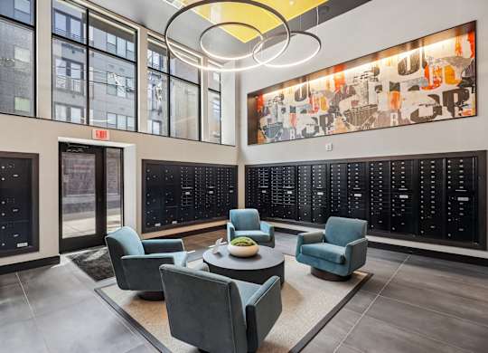 A modern office space with a large artwork on the wall and a view of the city outside the windows.