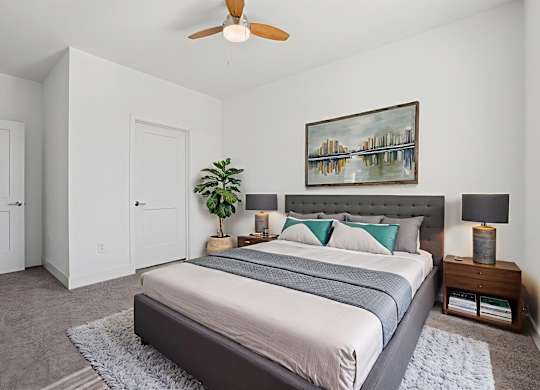 Bedroom at Contrast OTR in Cincinnati, OH featuring neutral tones, contemporary decor, and ceiling fan.