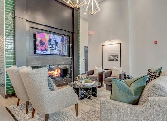 a living room with couches and chairs and a fireplace