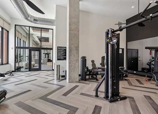 A gym with a variety of equipment including a squat rack.