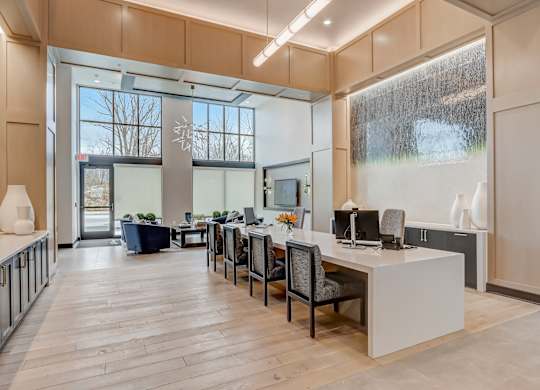 an office space with a desk and chairs and a large window