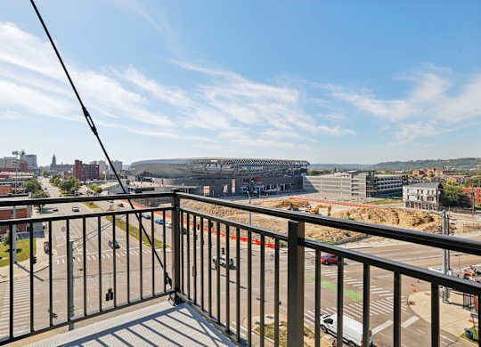 Private balcony at Contrast OTR apartments in Cincinnati, OH with sleek glass doors and city views.