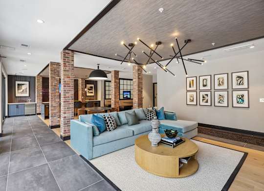 A living room with a blue couch and a coffee table.