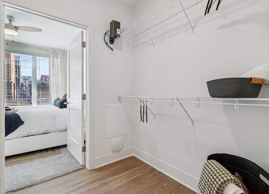 Spacious walk-in closet at Contrast OTR in Over-the-Rhine, Cincinnati with shelving and hardwood floors.