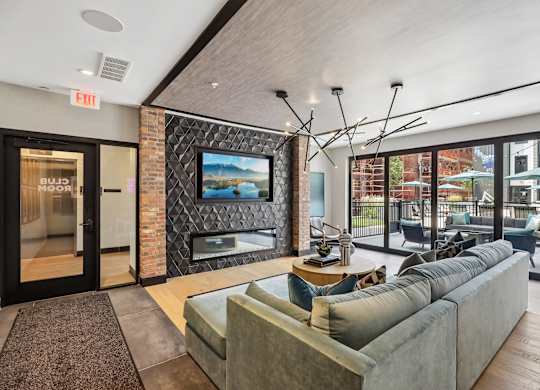 A living room with a couch, a television, and a fireplace.