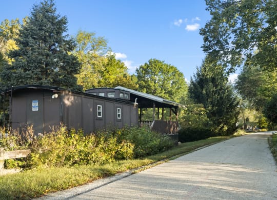 a house on the side of a road next to a path