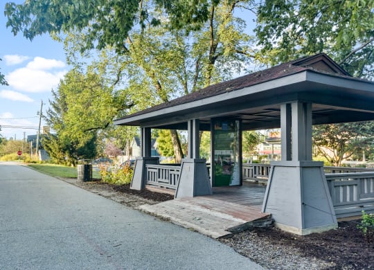a covered pavilion on the side of a road