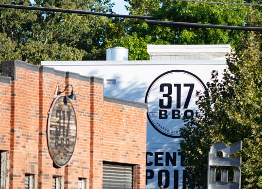 a sign that reads 312 bee in front of a brick building