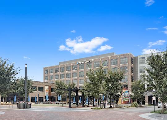 a large building with trees in front of it