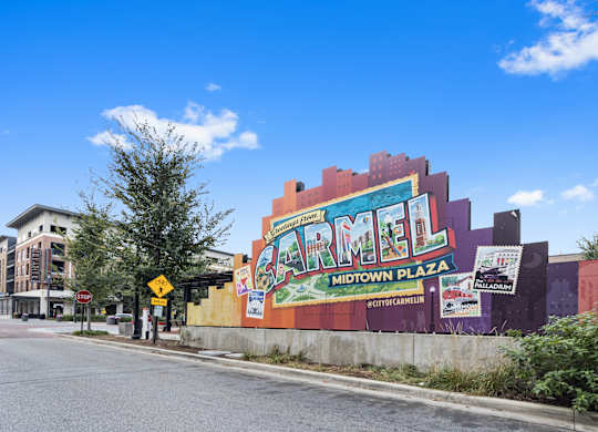 a mural on the side of a building on a city street