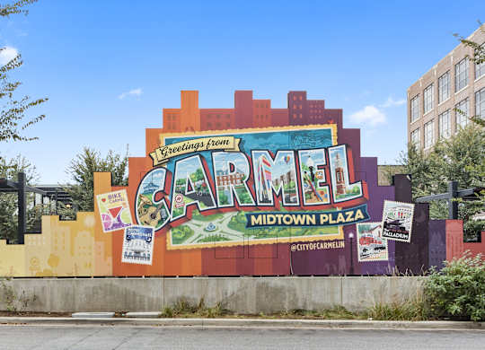 a large mural on the side of a building that reads carmel midtown plaza at Providence at Old Meridian Apartments , Carmel, IN