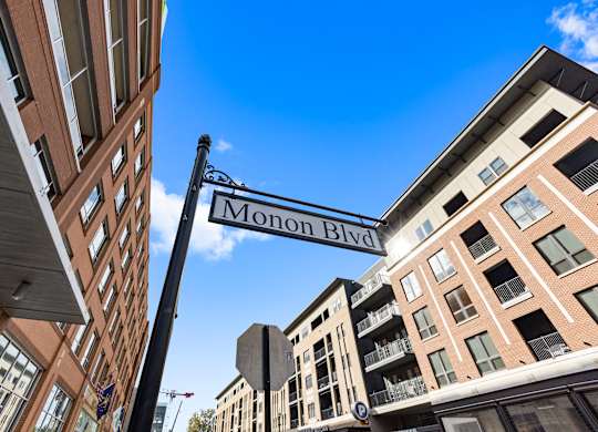 a street sign for monon blvd between two buildings at Providence at Old Meridian Apartments , Carmel, IN, 46032